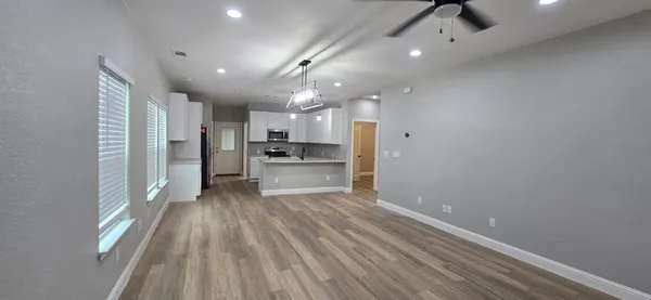 a view of a kitchen with a sink and refrigerator