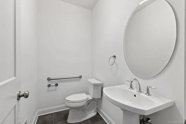 a bathroom with a sink a mirror and toilet