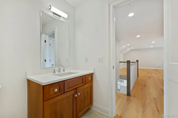 a bathroom with a sink a mirror and a shower