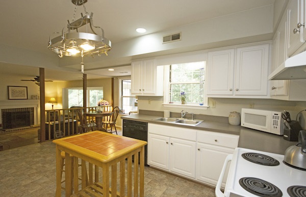 816 Harris Road Charlottesville, VA 22902 - Photo 4 of 28 a kitchen with a stove a sink a dining table and chairs