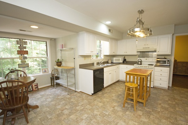 816 Harris Road Charlottesville, VA 22902 - Photo 5 of 28 a kitchen with refrigerator cabinets dining table and chairs