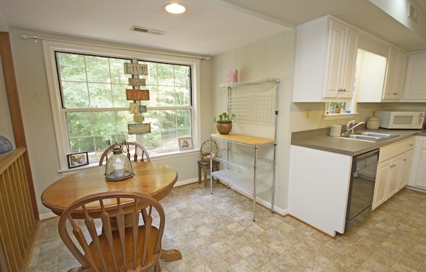 816 Harris Road Charlottesville, VA 22902 - Photo 7 of 28 a dining room with furniture a large window and a kitchen view