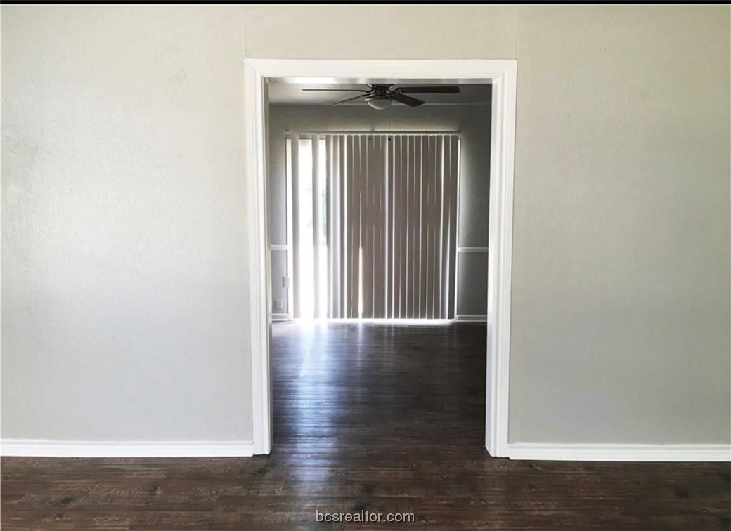 718 Edgewood Drive Bryan, TX 77802 - Photo 2 of 12 a view of wooden floor in a hall with a window