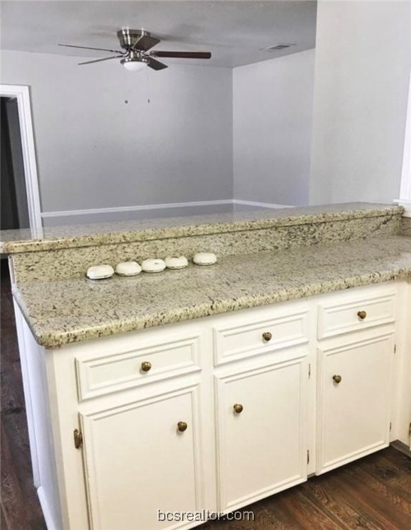 718 Edgewood Drive Bryan, TX 77802 - Photo 8 of 12 a view of a granite countertop white cabinets and a granite counter tops