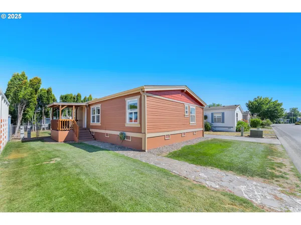 a front view of a house with a garden and yard
