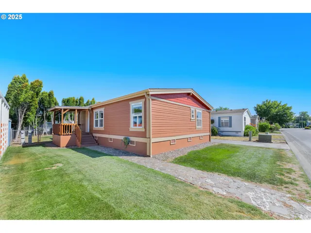 a front view of a house with a garden and yard