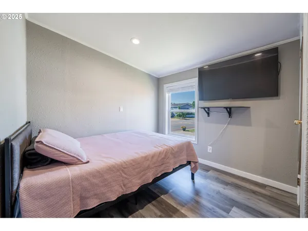 a bedroom with a bed and a flat screen tv