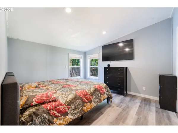 a bedroom with a bed and a flat screen tv