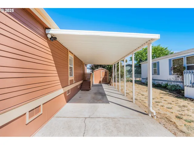 a view of a porch with furniture and floor to ceiling window
