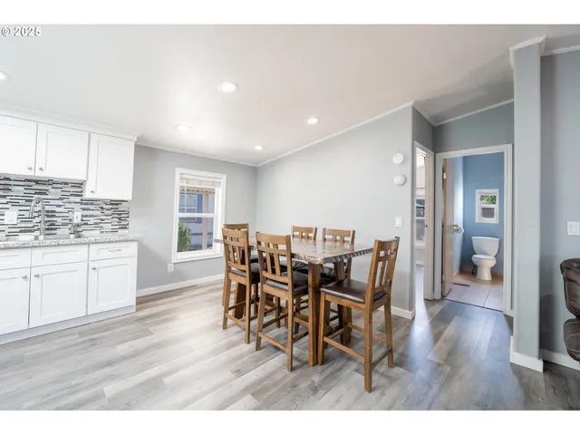 a dining room with furniture and wooden floor