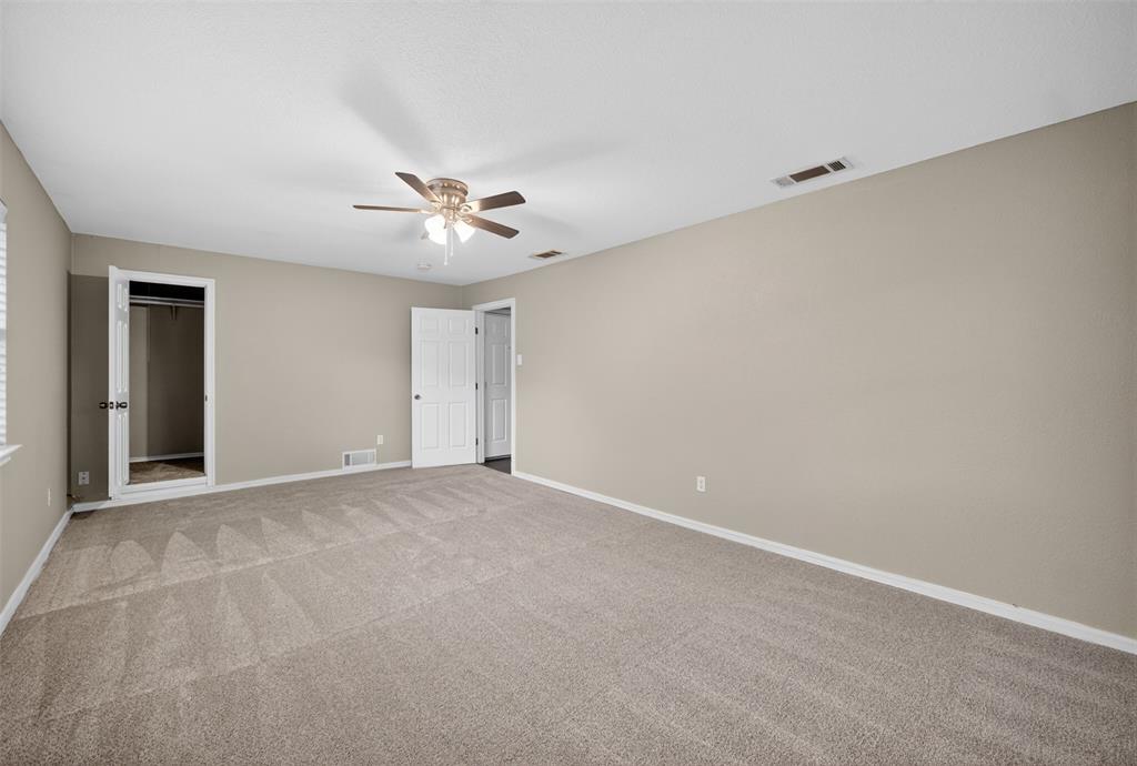 9660 Timberleaf Drive Dallas, TX 75243 - Photo 37 of 40 Spacious room featuring neutral paint, patterned carpet flooring, a ceiling fan with integrated lighting, and white trim