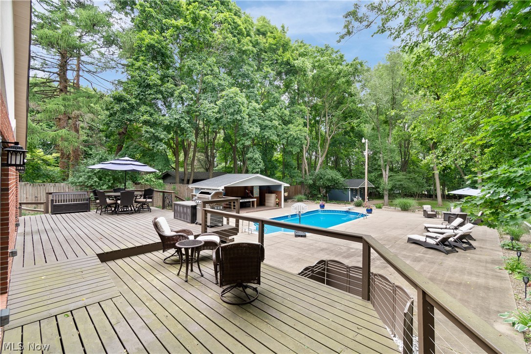 443 Merriman Road Akron, OH 44303 - Photo 33 of 44 Multi-level wood deck overlooking a concrete patio with an in-ground swimming pool