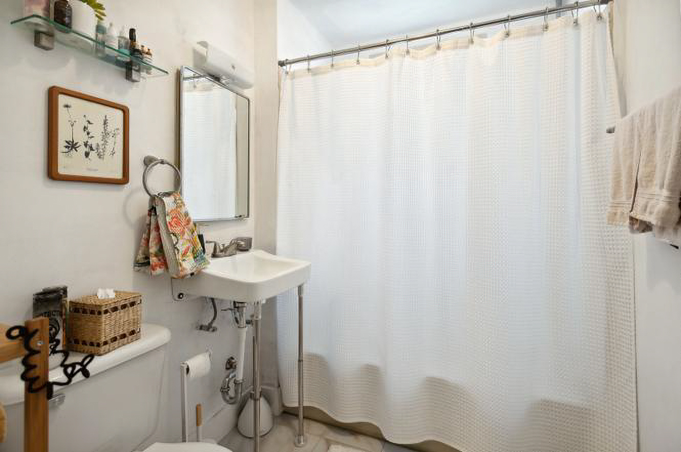 5128 West Henderson Street, Unit 2 Chicago, IL 60641 - Photo 8 of 9 a bathroom with a sink a mirror a window and a shower