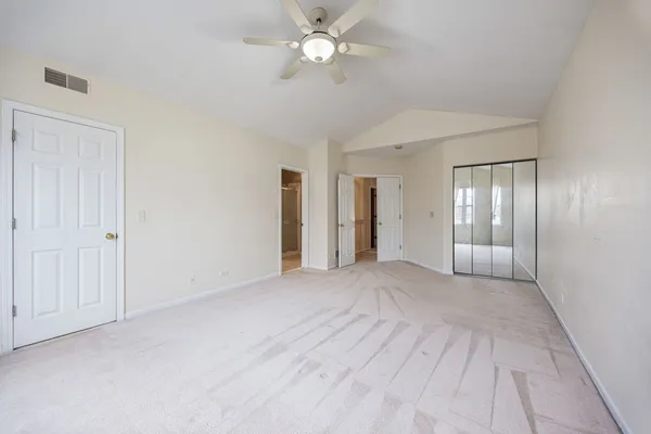 a view of an empty room with a ceiling fan