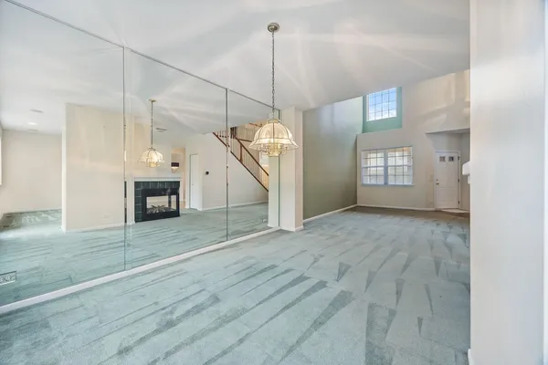 a view of a room with wooden floor and fireplace