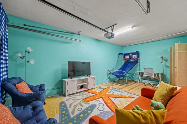 a bedroom with furniture and a flat screen tv