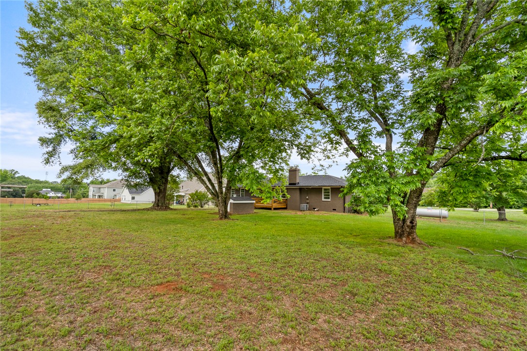 300 Vandiver Road Anderson, SC 29621 - Photo 24 of 30 A verdant backyard with mature trees provides ample space for outdoor living and recreation.