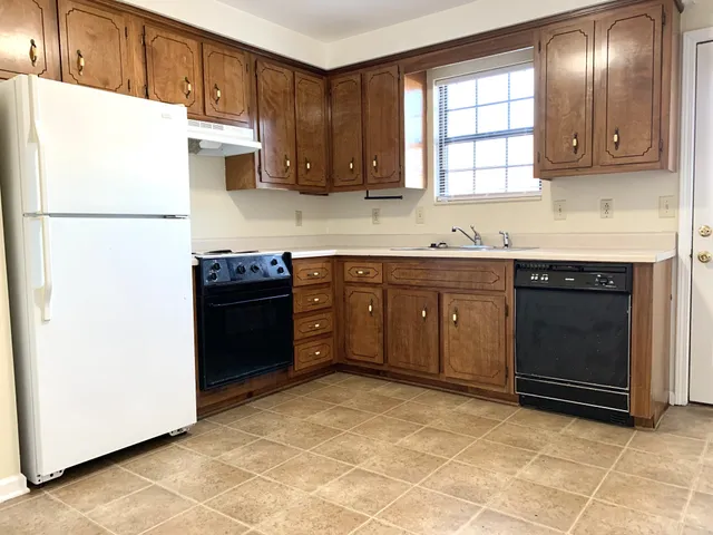 a kitchen with stainless steel appliances granite countertop a stove a refrigerator and a sink