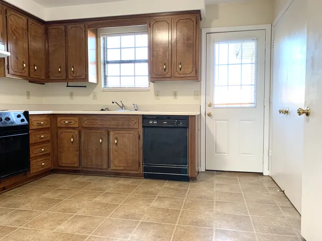 a kitchen with stainless steel appliances granite countertop a stove a sink and a cabinets