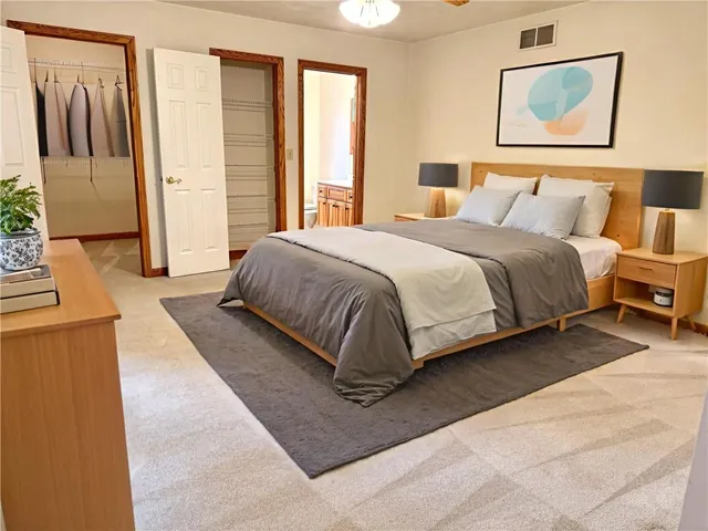 a spacious bedroom with a bed and a couch