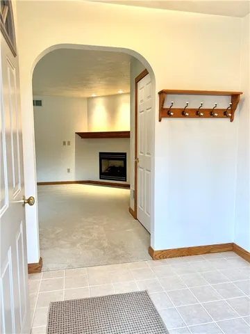 a view of empty room with a fireplace