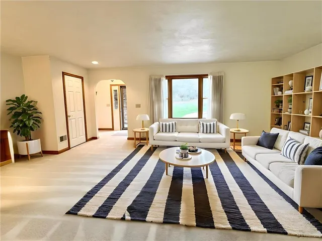 a living room with furniture and a rug