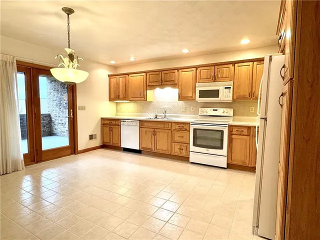 a kitchen with stainless steel appliances granite countertop a stove and a refrigerator