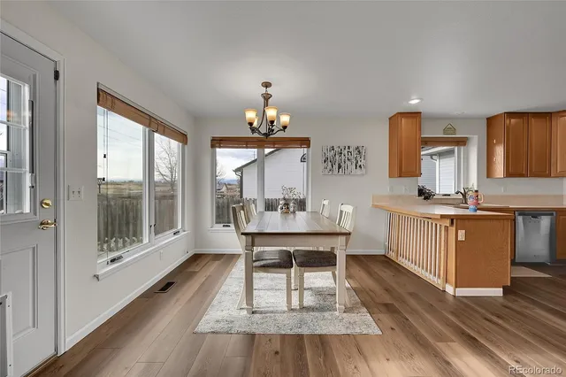 a kitchen with a sink cabinets and wooden floor