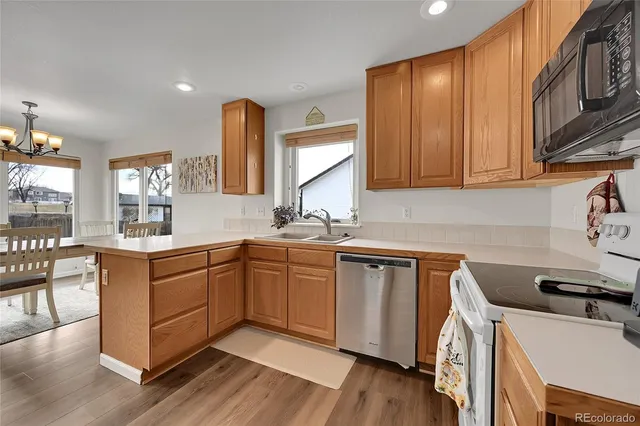a kitchen with a sink stove and refrigerator