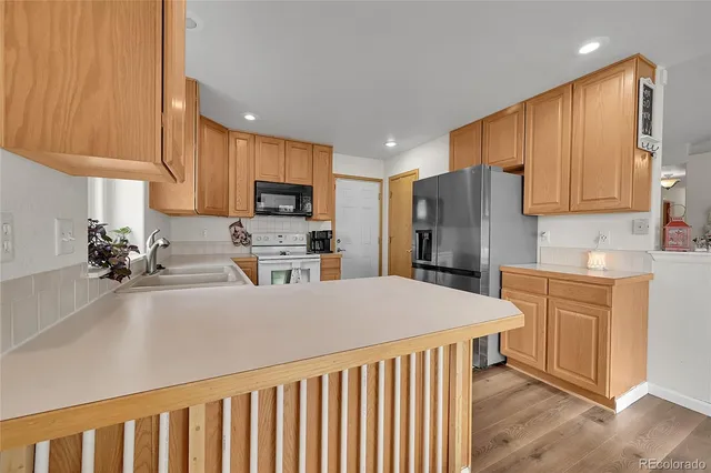 a kitchen with a sink cabinets and appliances