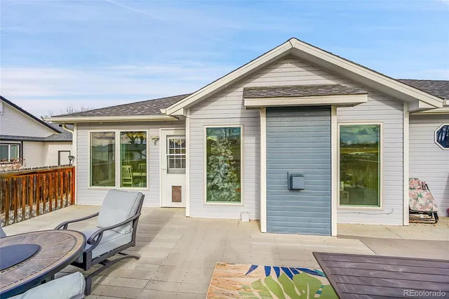 a view of a balcony with chairs and wooden floor