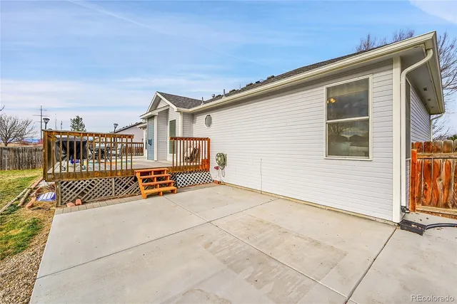 a view of a lake with a big yard and large trees