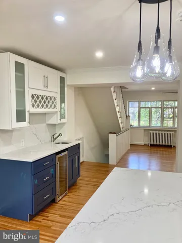 a view of a room with wooden floor and windows