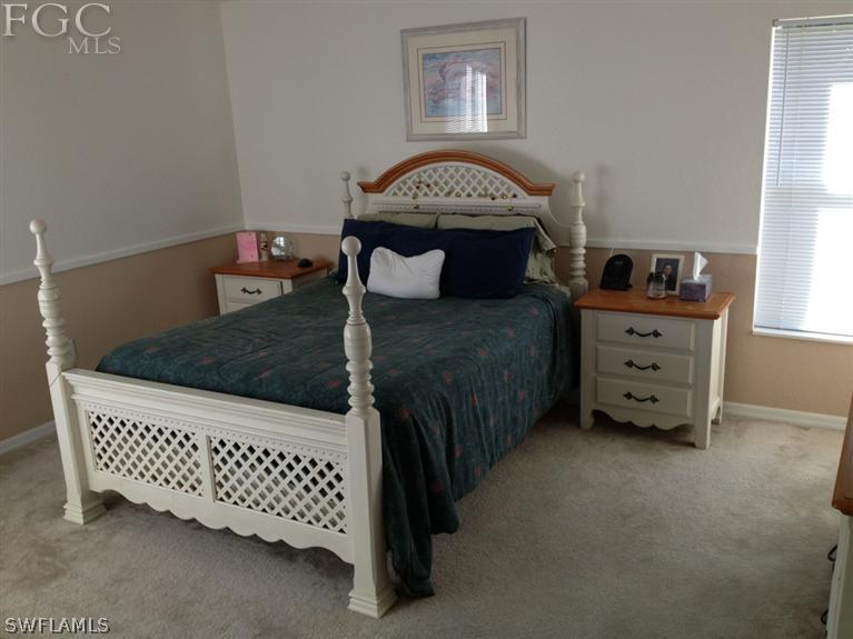 6022 Stratton Road Fort Myers, FL 33905 - Photo 2 of 5 a bedroom with a bed and a window
