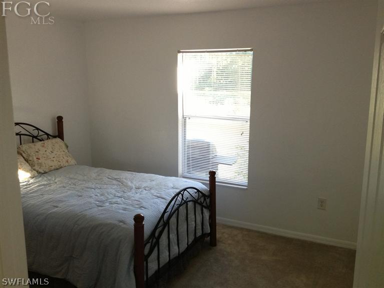 6022 Stratton Road Fort Myers, FL 33905 - Photo 3 of 5 a bed sitting in a bedroom next to a window