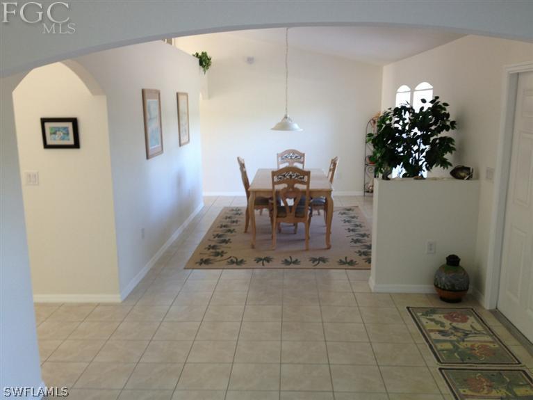6022 Stratton Road Fort Myers, FL 33905 - Photo 4 of 5 a dining room with furniture and a potted plant