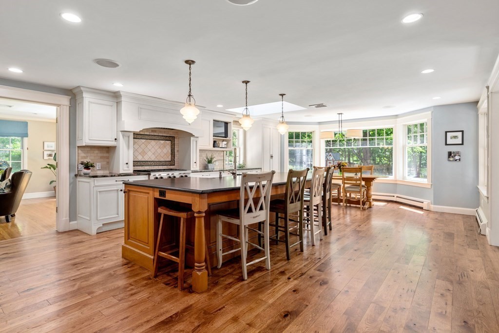 5 Deerfield Road Sherborn, MA 01770 - Photo 11 of 42 a large kitchen with lots of furniture a sink appliances and dining table