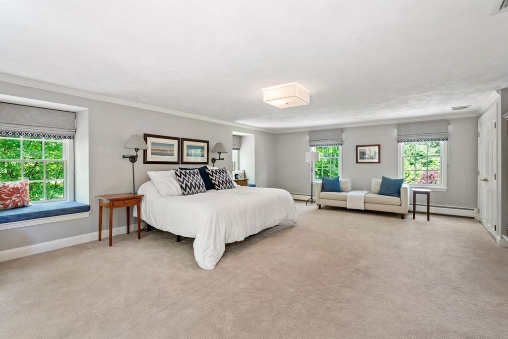 5 Deerfield Road Sherborn, MA 01770 - Photo 24 of 42 a spacious bedroom with a bed and a couch