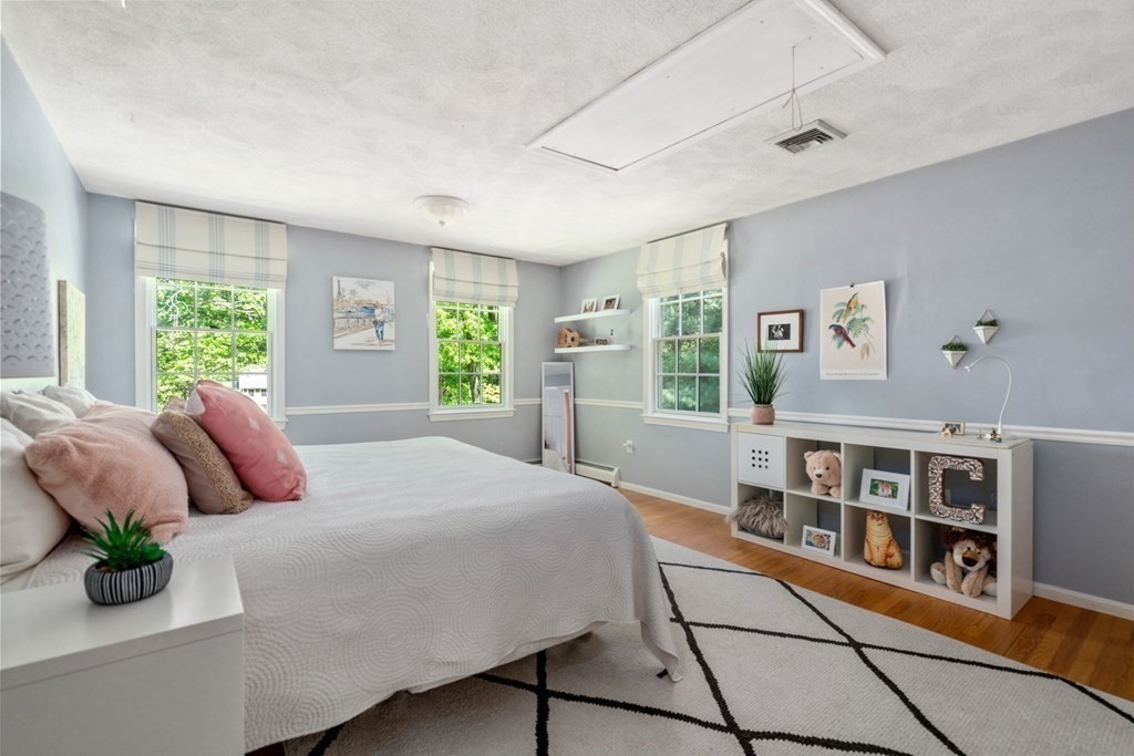 5 Deerfield Road Sherborn, MA 01770 - Photo 28 of 42 a bedroom with a large bed and a window