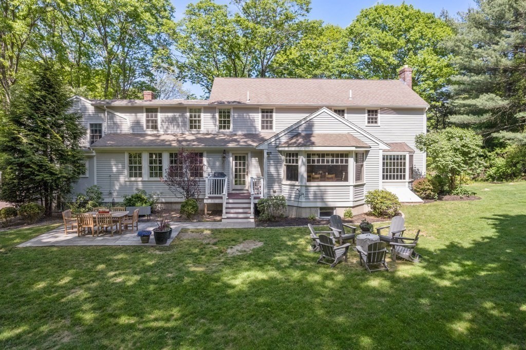 5 Deerfield Road Sherborn, MA 01770 - Photo 3 of 42 a front view of a house with a garden and patio
