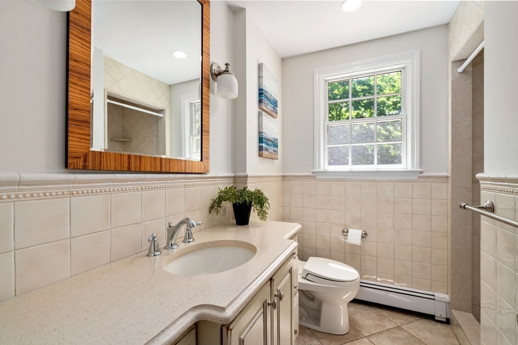 5 Deerfield Road Sherborn, MA 01770 - Photo 34 of 42 a bathroom with a sink a toilet and a mirror