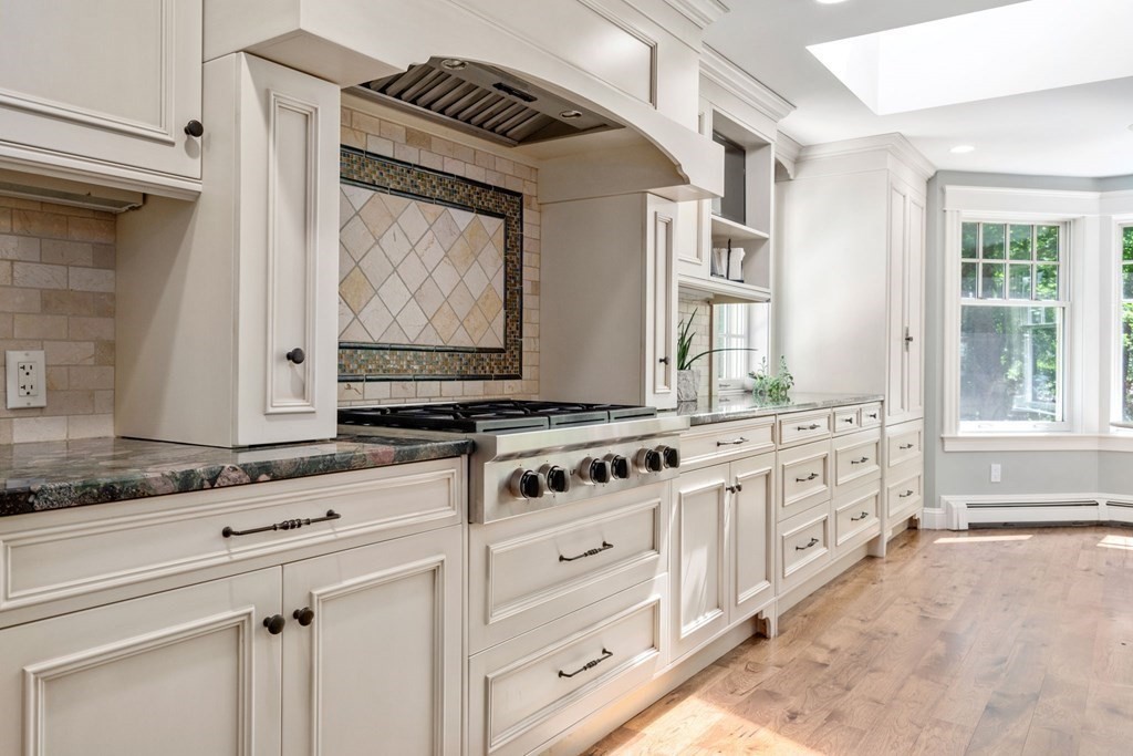 5 Deerfield Road Sherborn, MA 01770 - Photo 9 of 42 a kitchen with granite countertop white cabinets and white appliances
