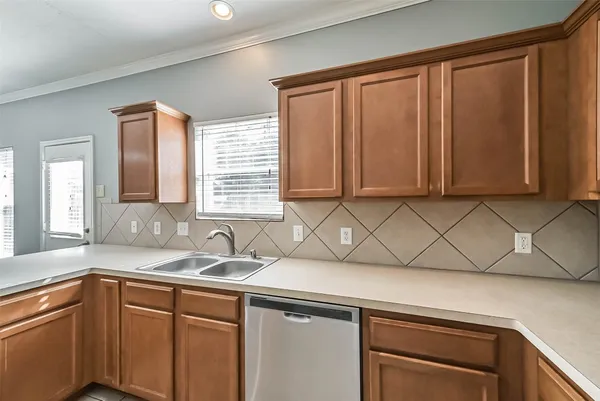 a kitchen with stainless steel appliances wooden cabinets and a sink