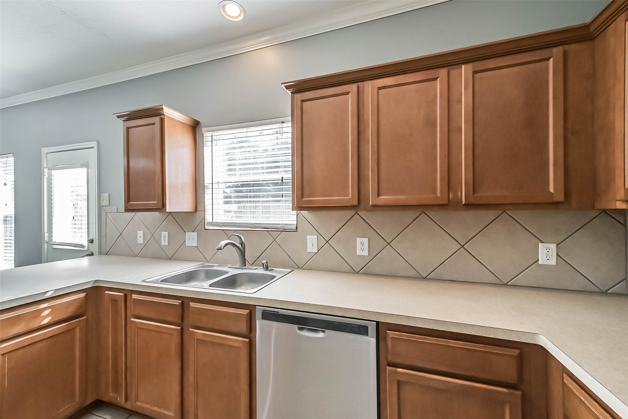 8726 Old Maple Lane Humble, TX 77338 - Photo 11 of 35 a kitchen with stainless steel appliances wooden cabinets and a sink
