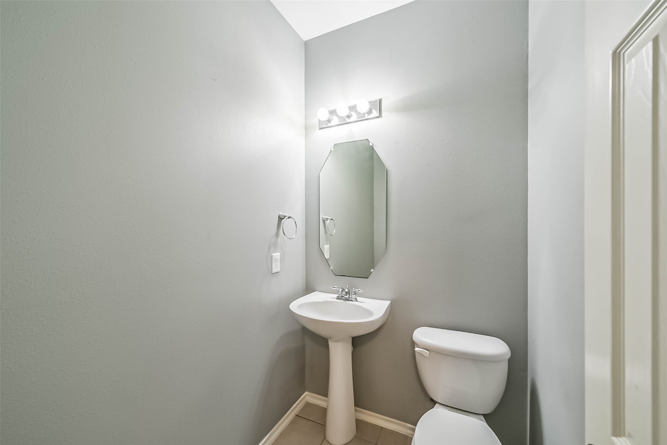 8726 Old Maple Lane Humble, TX 77338 - Photo 15 of 35 a bathroom with a toilet sink and mirror