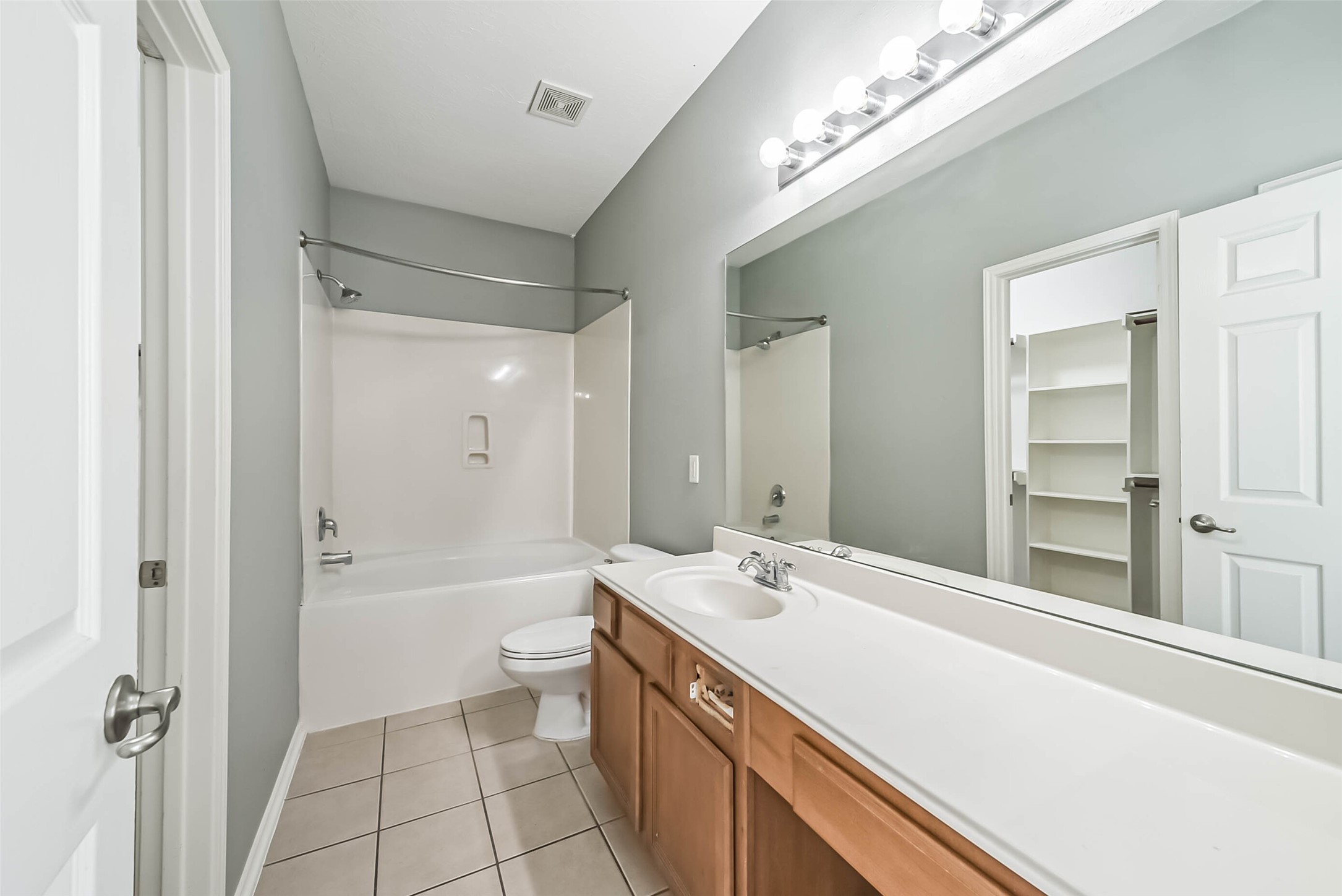 8726 Old Maple Lane Humble, TX 77338 - Photo 18 of 35 a bathroom with a double vanity sink toilet mirror and bathtub