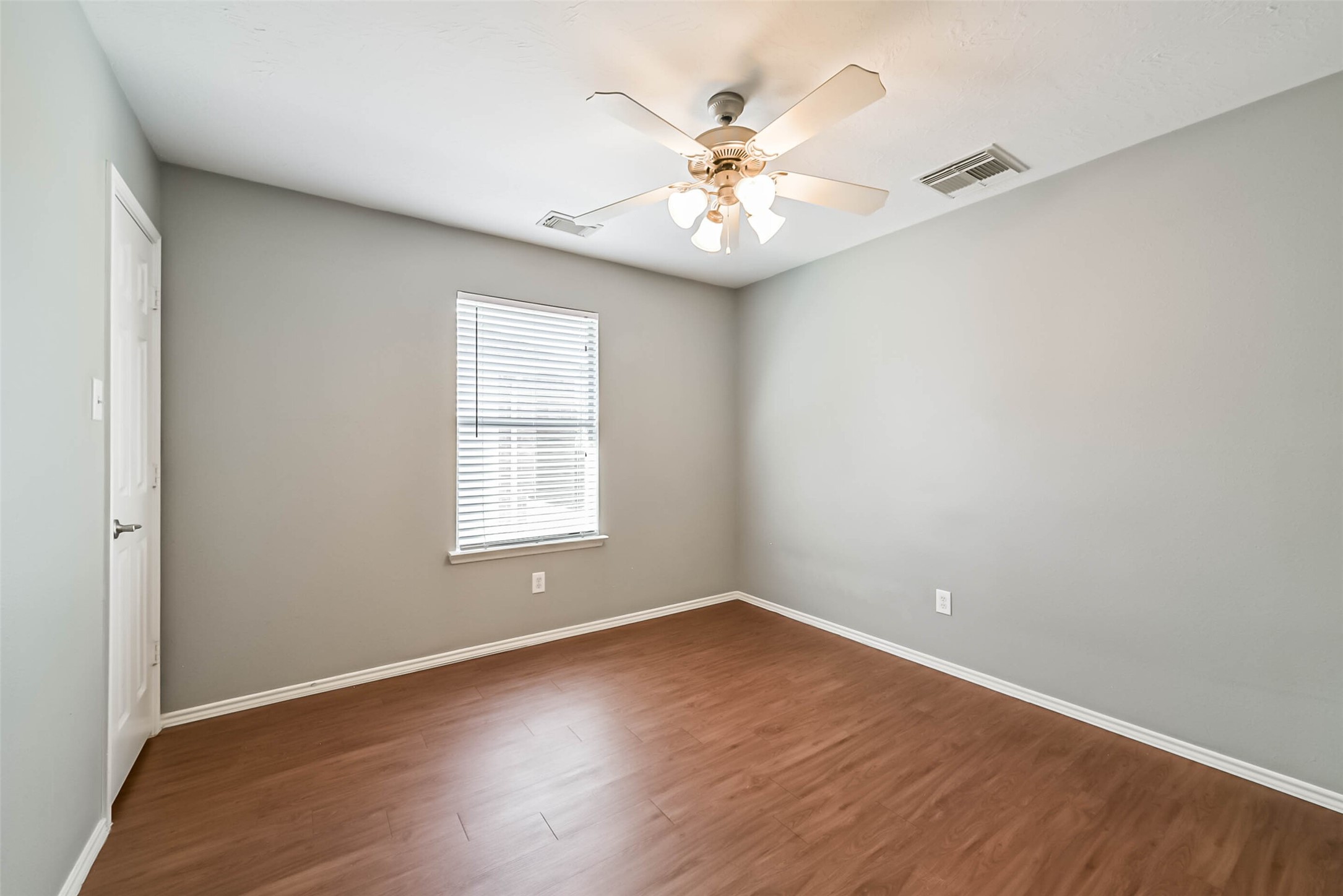 8726 Old Maple Lane Humble, TX 77338 - Photo 24 of 35 an empty room with wooden floor and windows