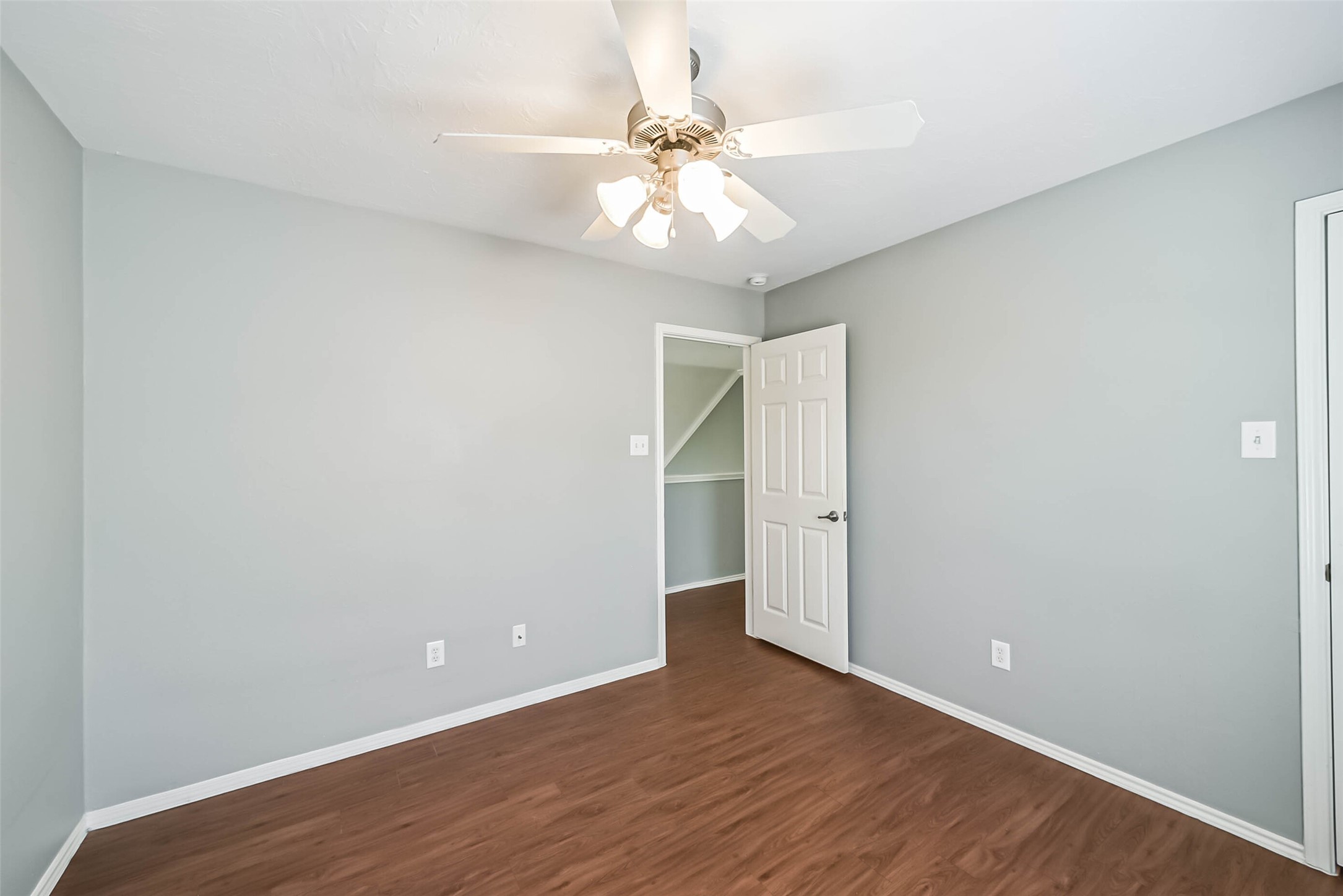 8726 Old Maple Lane Humble, TX 77338 - Photo 26 of 35 a view of an empty room with wooden floor and a ceiling fan