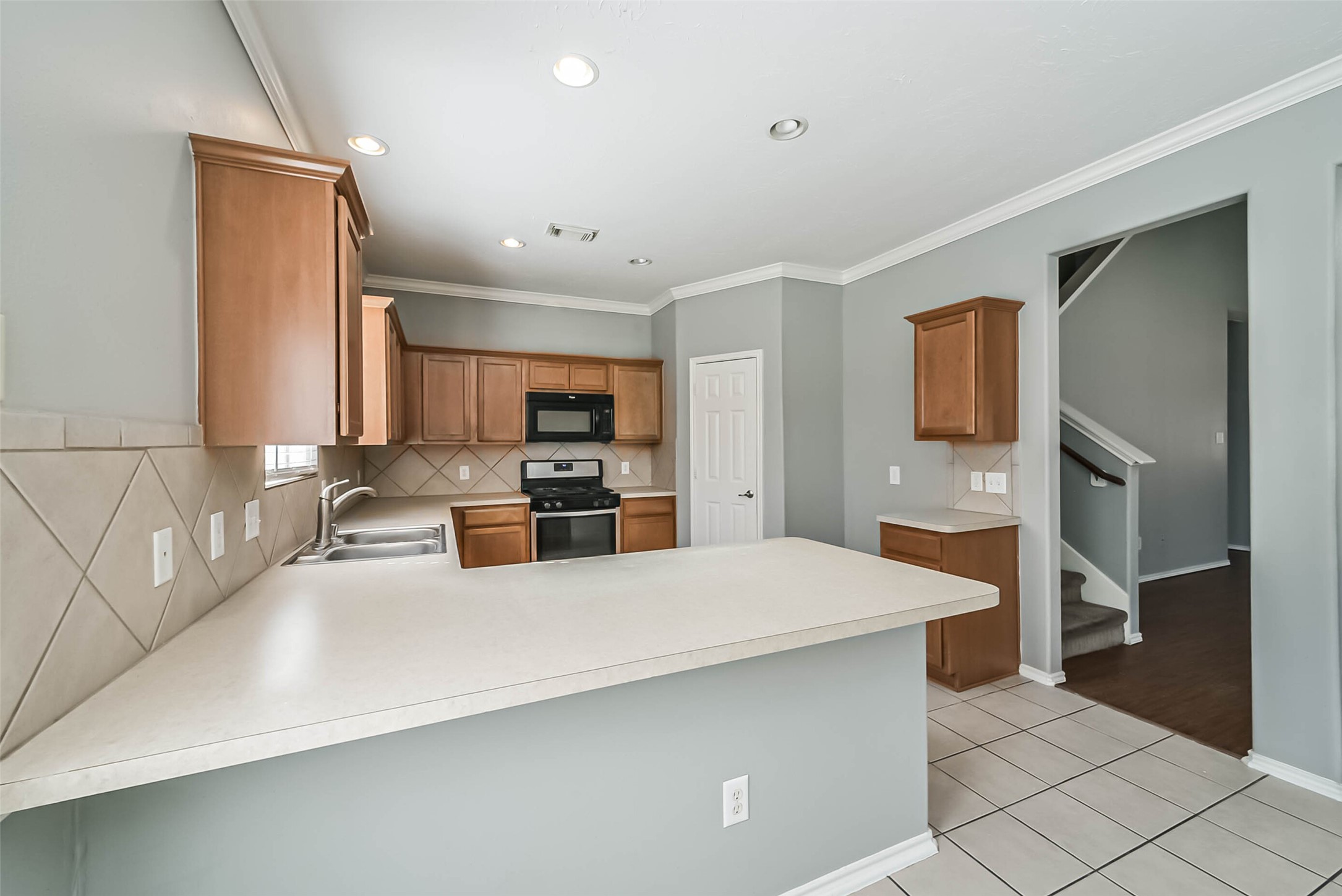 8726 Old Maple Lane Humble, TX 77338 - Photo 8 of 35 a large kitchen with a large counter top stainless steel appliances and cabinets
