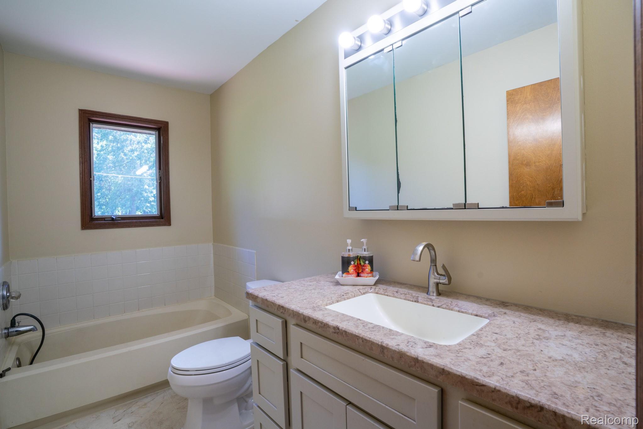 12900 Maxwell Road Carleton, MI 48117 - Photo 54 of 59 Integrated bathtub and shower combination with white tile surround